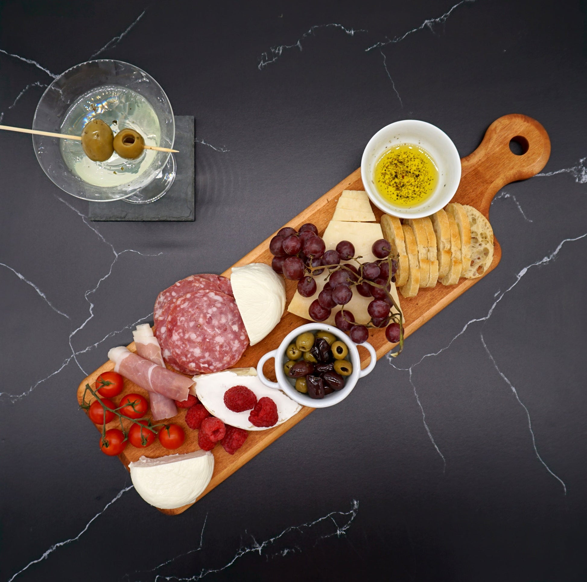 Maple Artisan Plank Serving Board-20" x 6" with charcuterie and a martini.