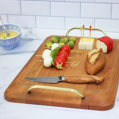 JK Adams Cherry Handled Serving Board with Brass Handles,  cheese, bread and olives on board.