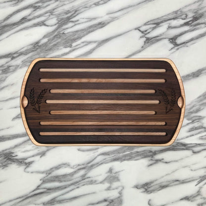 Wooden cutting board with slotted design on a marble surface