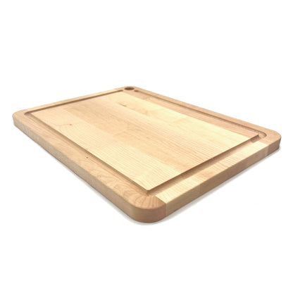 Maple cutting board with a small juice groove on a white background.
